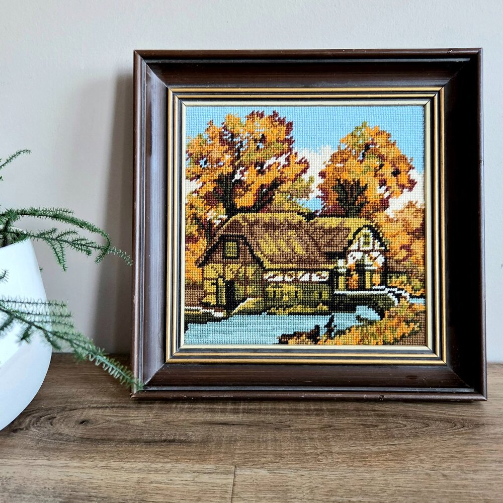 Vintage embroidery needlepoint cross stitched picture with house and trees.